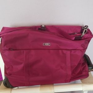 Burgandy Tumi wheeled duffel weekend travel bag